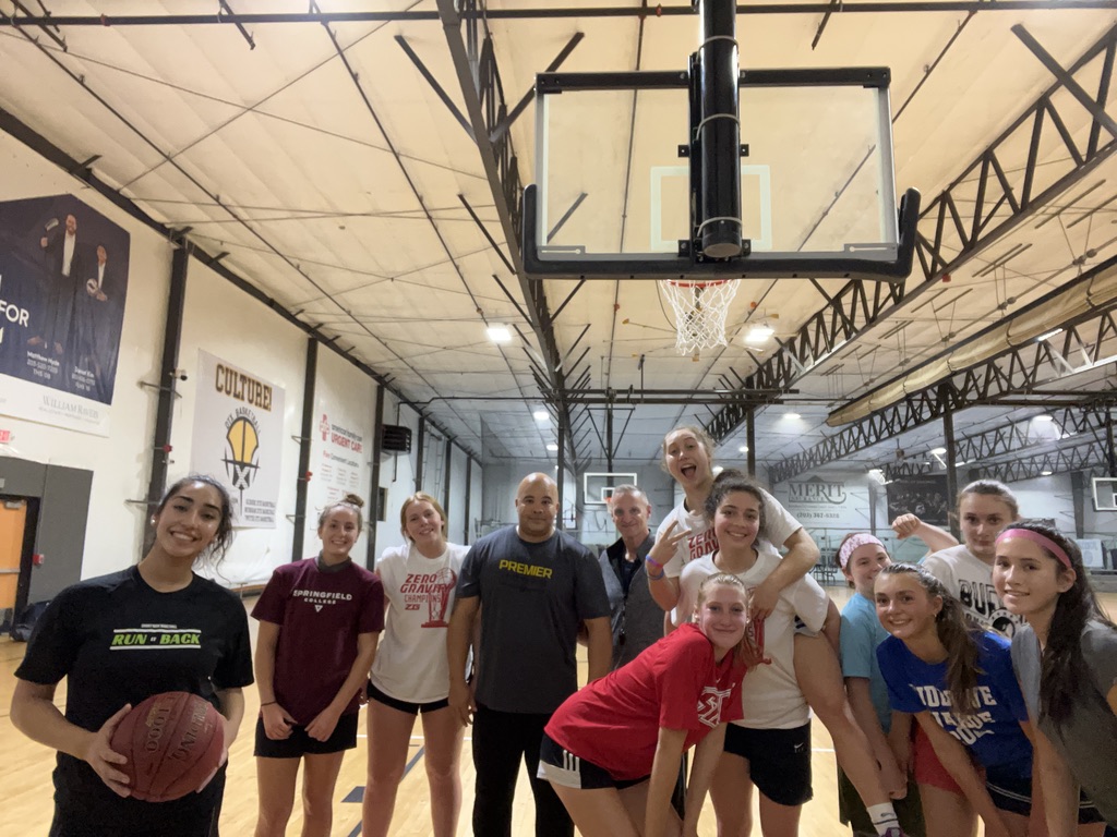 Players and coaches gathered under the hoop in the gym