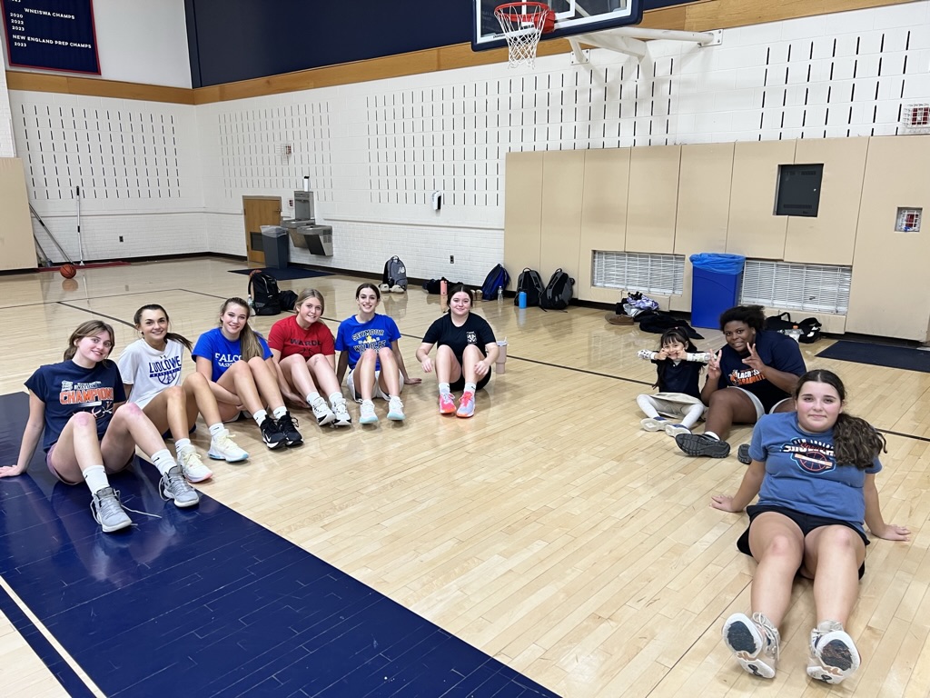 Campers sitting together on the gym floor after a session