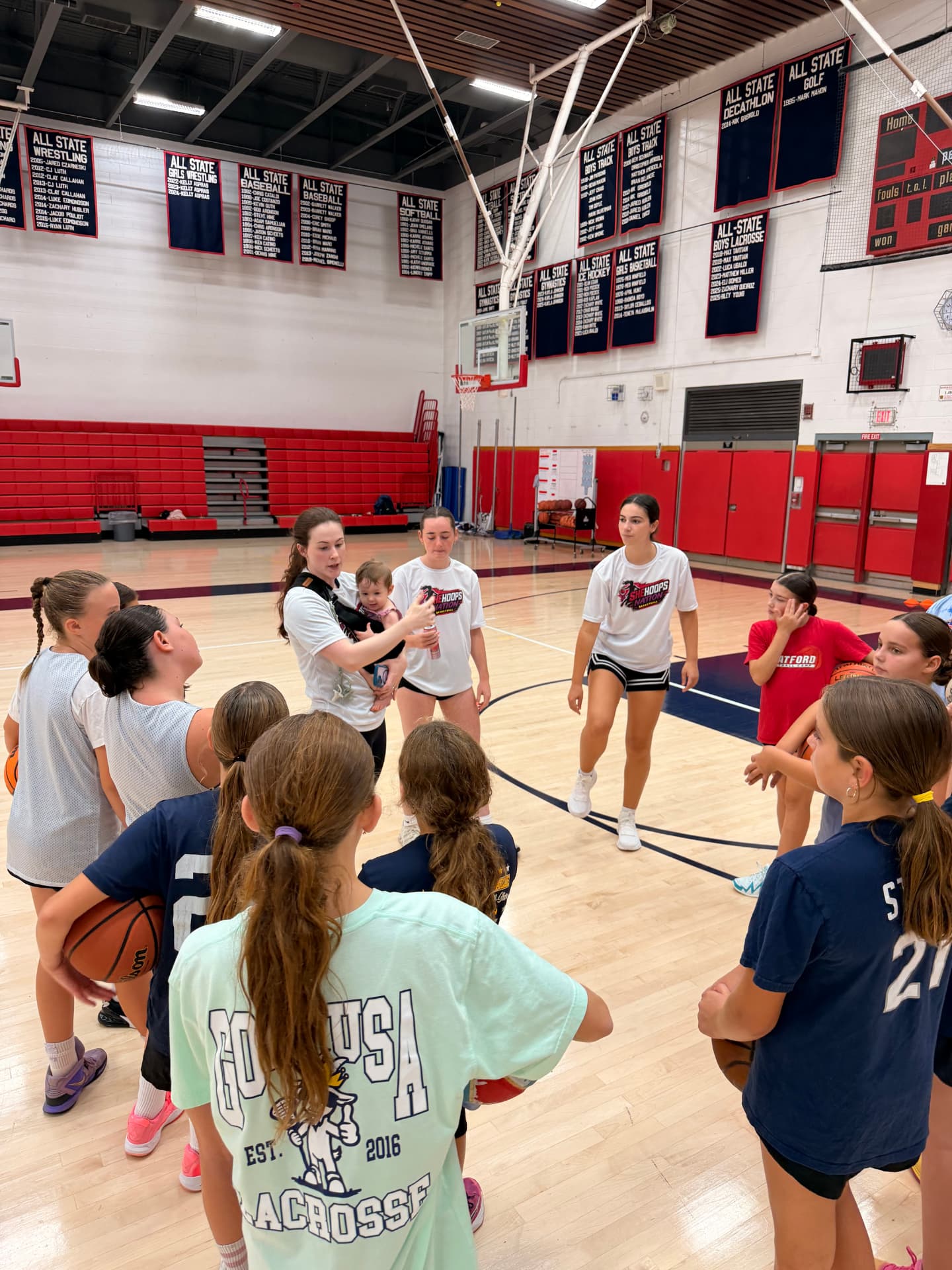 Coaches leading a team huddle at practice